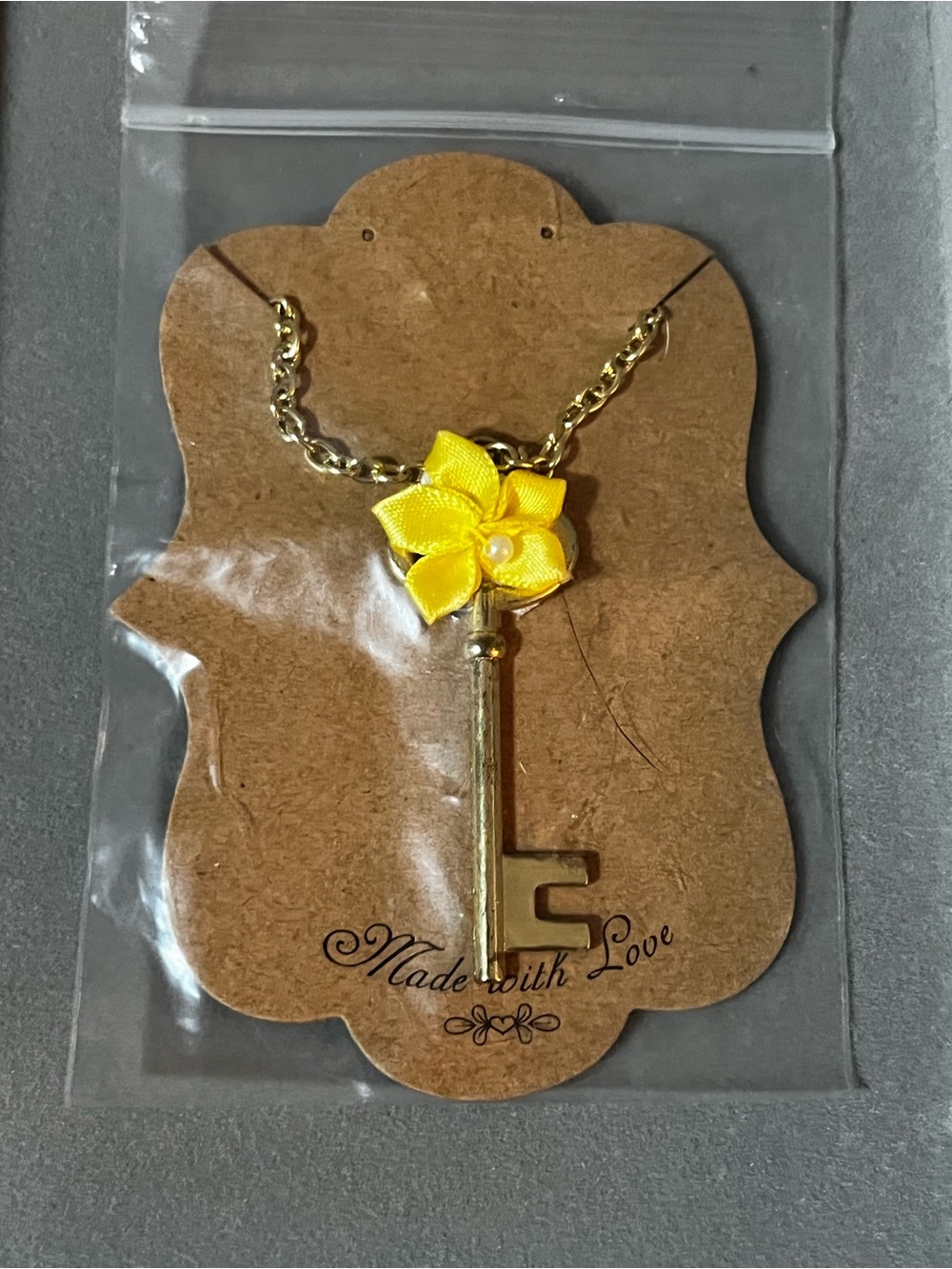 Gold Key Pendant Necklace with Yellow Flower Accent
